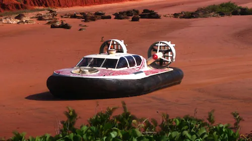 A photo of a hovercraft floating above a mud flat near Broome, Australia