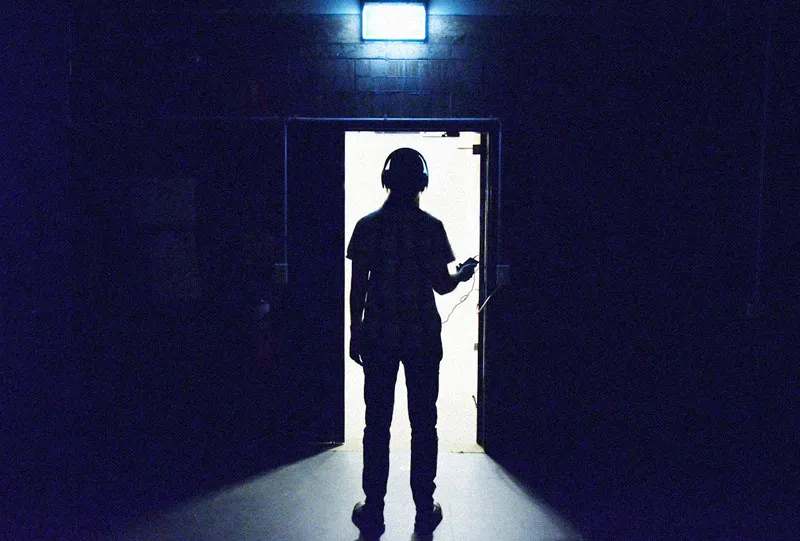 Photo of a man silhouetted in a doorway.