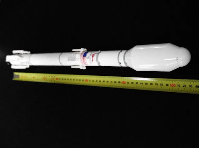 Close up of lego falcon 9 full launch vehicle next to tape measure.