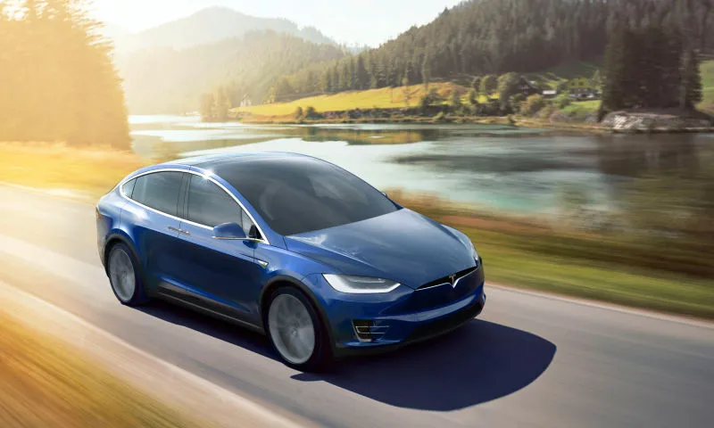 Rendering of a blue tesla model-x racing along a river. Featuring heavy use of motion blur.