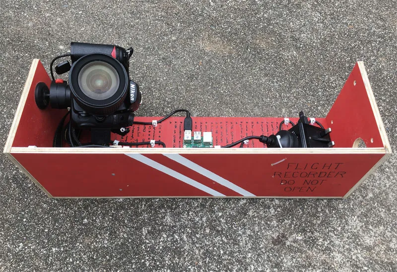 Photo of a raspberry pi time-lapse rig that has been made to resemble a flight recorder.
