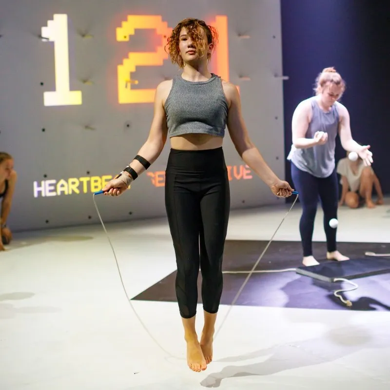 A photo of a circus performer wearing a theatrical heart rate monitor.