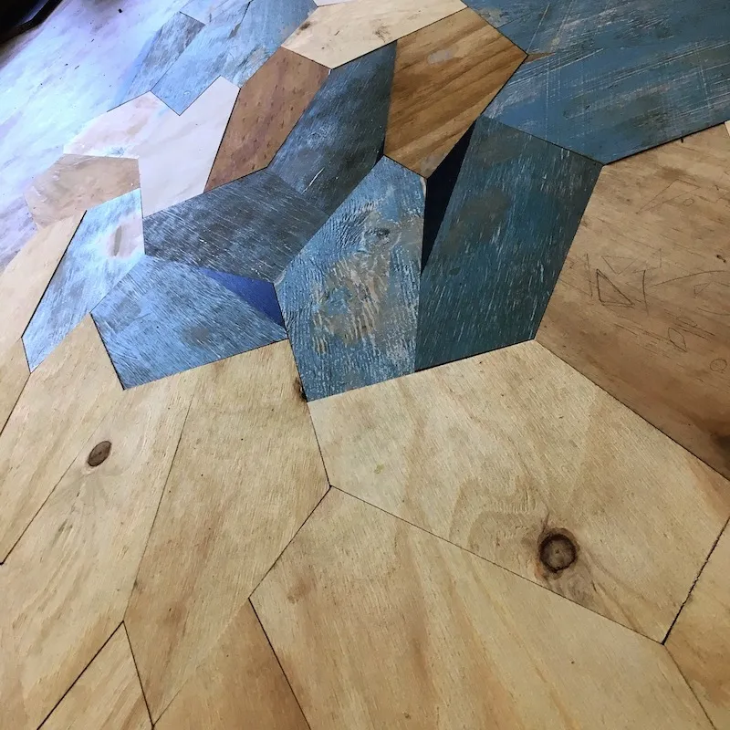 Picture of plywood being cut into type14 pentagon tiles.