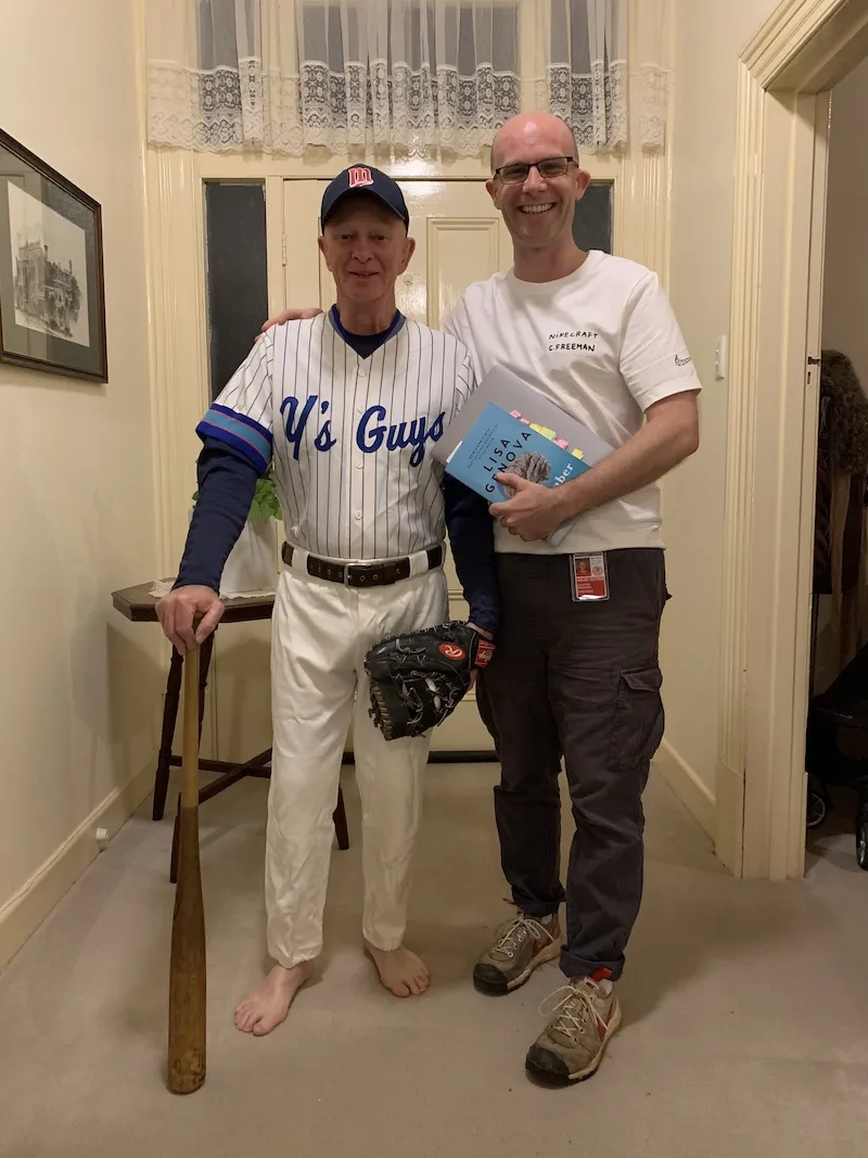A photo of me with my Dad. He is wearing his baseball uniform and I'm wearing my weartester uniform.