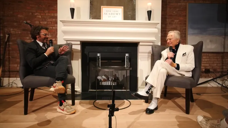 A photo of a Tom Sachs sitting with Tom Wolfe.