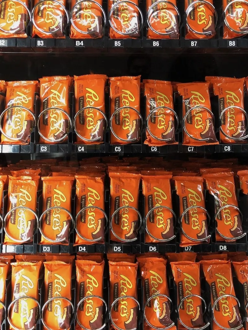 A closeup photo of Tom Sachs chocolate bars in a vending machine.