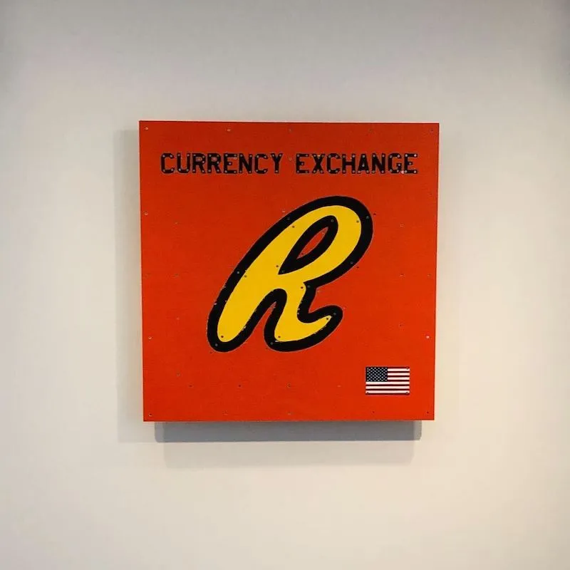 A photo of a currency exchange painting by Tom Sachs.