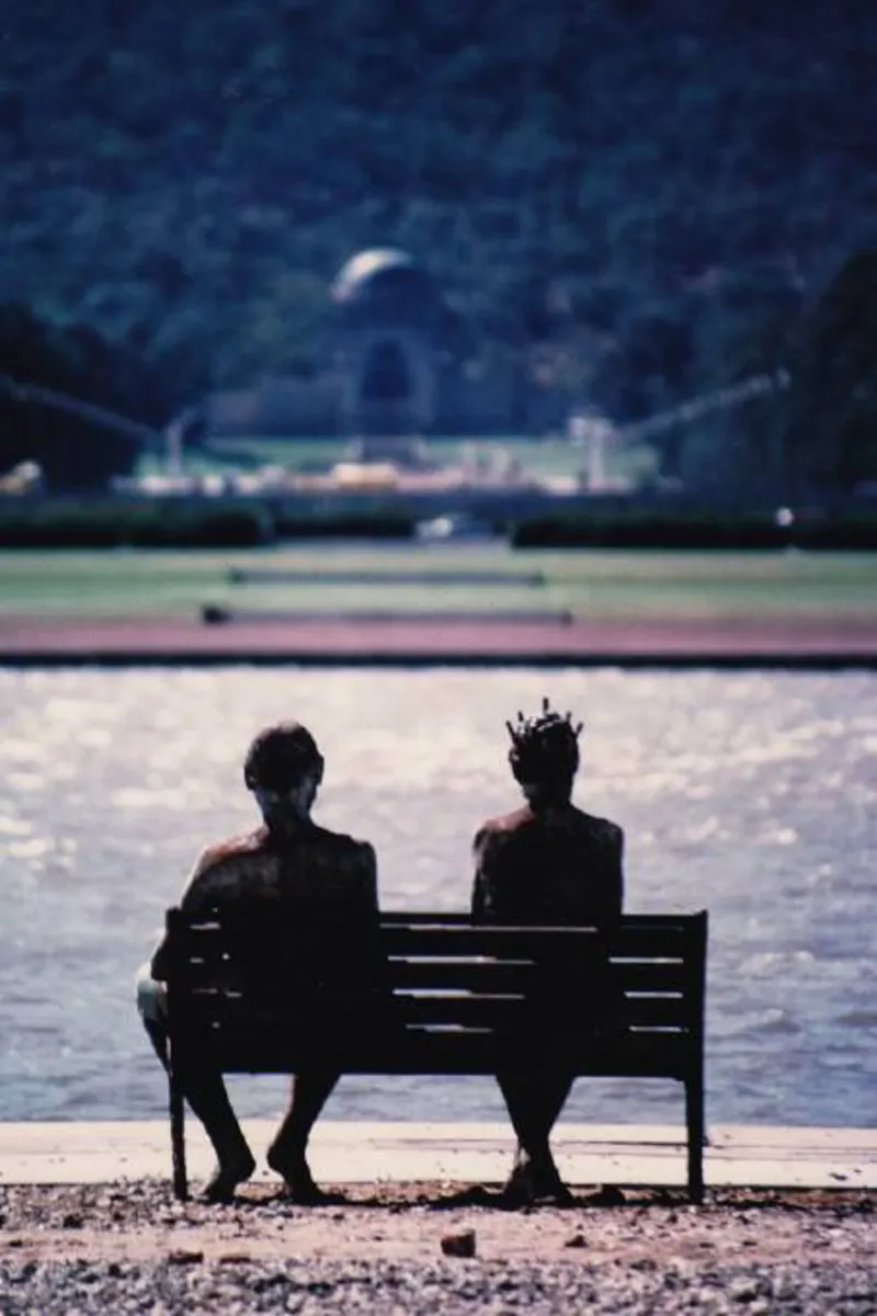 A photo of the sculpture down by the lake with liz and phil by Greg Taylor, installed next to lake burley griffin.