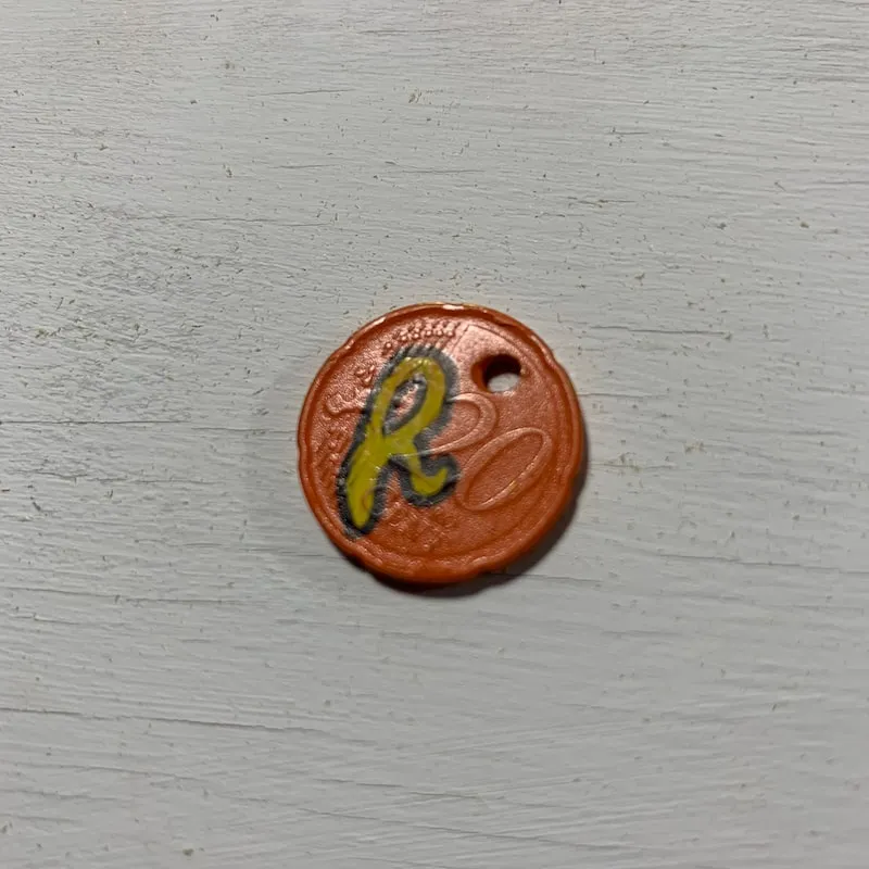 A photo of a 20 euro cent painted with the Reeces logo by Arthur Carpentier